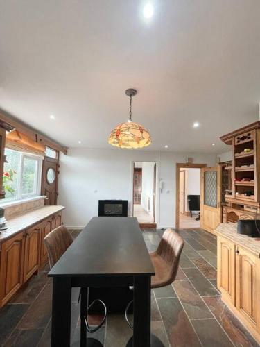 a kitchen with a table and chairs in a room at Quiet self-catering holiday home with surrounding lakes in Bailieborough