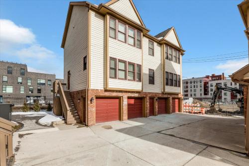 a large house with a garage in a city at The Lumber Baron's Mansion: 2 King Suites, 2.5BA + Gym in Detroit