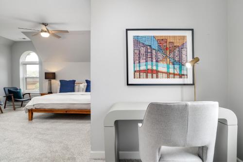 a bedroom with a bed and a chair at The Lumber Baron's Mansion: 2 King Suites, 2.5BA + Gym in Detroit