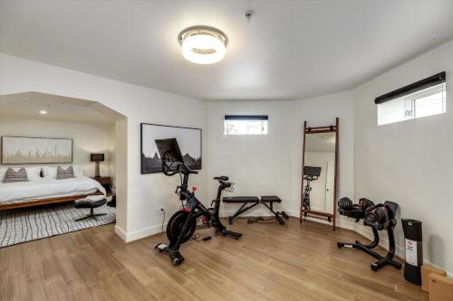 a bedroom with a bed and exercise bikes in it at The Lumber Baron's Mansion: 2 King Suites, 2.5BA + Gym in Detroit
