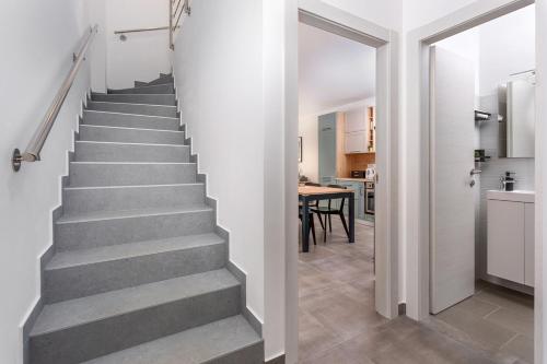 a staircase in a house with a kitchen and a dining room at Holiday house Bibi in Punat