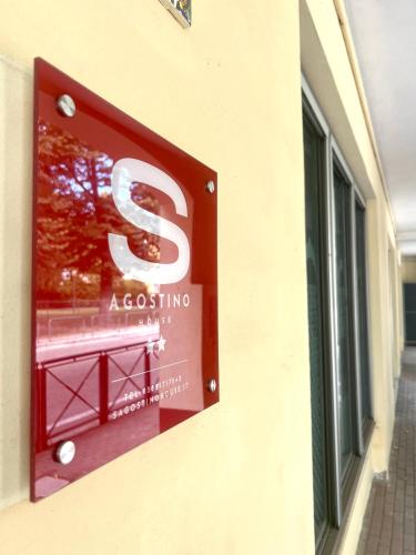 a s expecting sign on the side of a building at SAGOSTINO HOUSE in SantʼAgostino