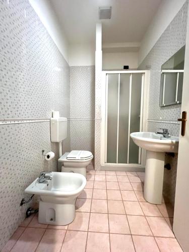 a bathroom with a toilet and a sink at SAGOSTINO HOUSE in SantʼAgostino