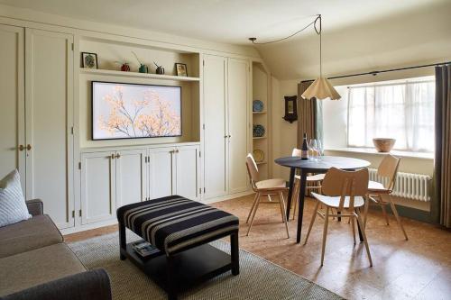 a living room with a table and a dining room at Dawn at The Sun Inn Felmersham, Our Signature Duplex Suite in Sharnbrook