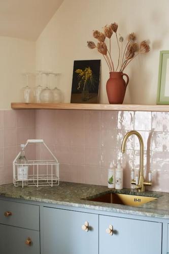 a kitchen with a sink and a counter top at Dawn at The Sun Inn Felmersham, Our Signature Duplex Suite in Sharnbrook