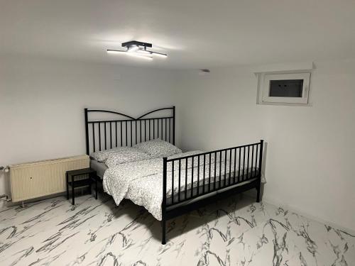 a bedroom with a bed in a white room at Nice Calm Souterrain Appertment in Ratingen in Ratingen