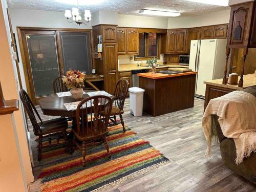 a kitchen and dining room with a table and chairs at A great house by Fonner Park in Grand Island