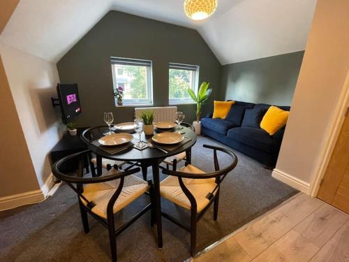 a living room with a table and a couch at Luxury 1 bed Flat + sofa bed- Dudley 