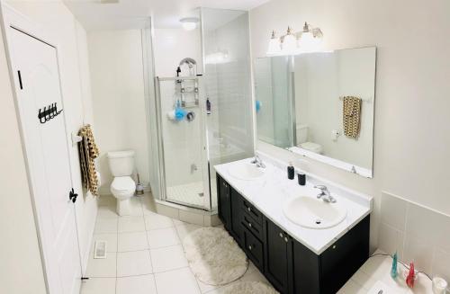 uma casa de banho com um lavatório, um chuveiro e um WC. em Luxurious Executive Style Townshouse with parking em East Gwillimbury