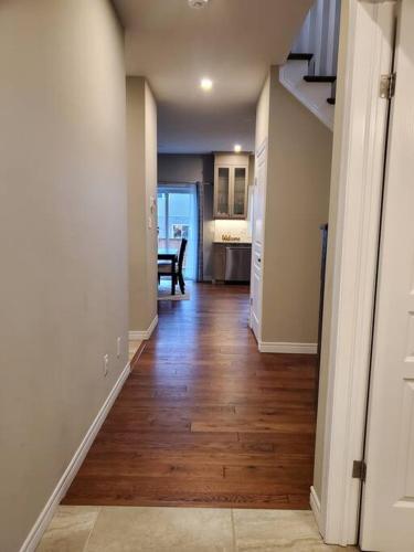 an empty hallway of a house with a wooden floor at 4 BD Family Retreat - Basement not Included in Stratford