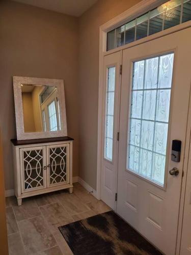 a room with a door and a mirror next to a door at 4 BD Family Retreat - Basement not Included in Stratford