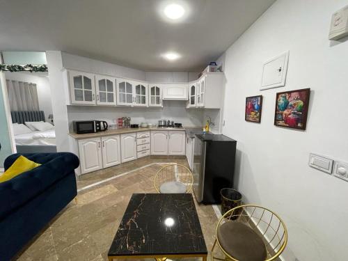 a kitchen with a couch and a table in a room at Apartment in Islamabad F-10 in Rawalpindi