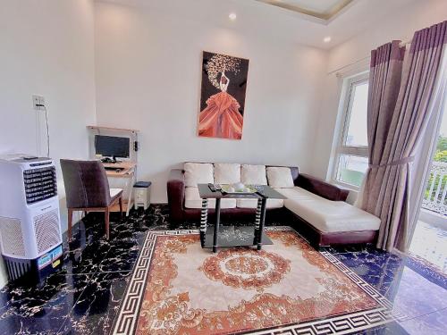a living room with a couch and a table at Godiva Villa Phu Quoc in Phu Quoc