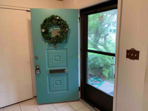 a blue door with a wreath on it next to a window at Vacation home in Melbourne