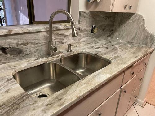 a kitchen with a stainless steel sink in a kitchen at Vacation home in Melbourne
