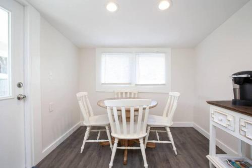 a dining room with a table and four chairs at Bright, Immaculate and Cozy Coastal Cottage in Ozona in Palm Harbor