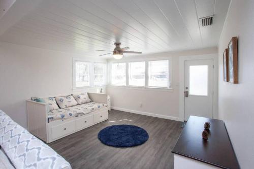 a living room with a couch and a table at Bright, Immaculate and Cozy Coastal Cottage in Ozona in Palm Harbor