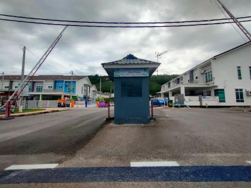 an empty street with a bus stop in the middle at Humaira Homestay Jitra in Jitra