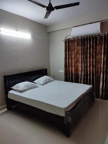 a bedroom with a bed and a ceiling fan at Rahul's Castle Guest House in Visakhapatnam