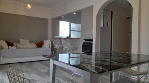 a living room with a glass table and a couch at TORRE Rivera in Buenos Aires