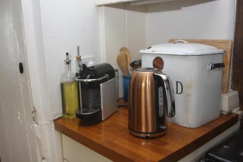 a counter top with a coffee maker and a coffee pot at Fishermans Cottage built in 1705 in Hastings