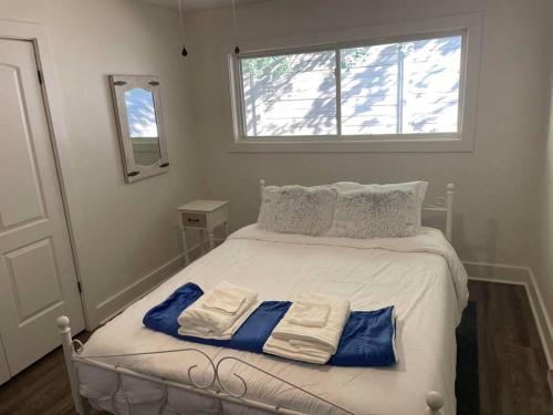 a bedroom with a bed with two towels on it at Charming 2Br, Fully Equipped kitchen, Smart TV in Greenville