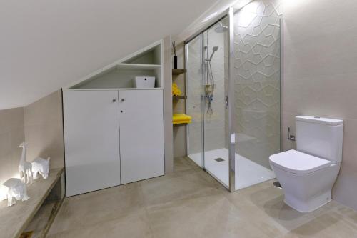 a bathroom with a toilet and a walk in shower at Home2Book Modern Design Seaview Apt, Pool&Terrace in Playa de las Americas