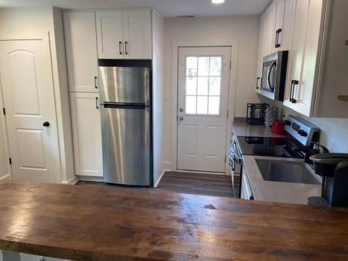 a kitchen with a stainless steel refrigerator in it at Charming 2Br, Fully Equipped kitchen, Smart TV in Greenville