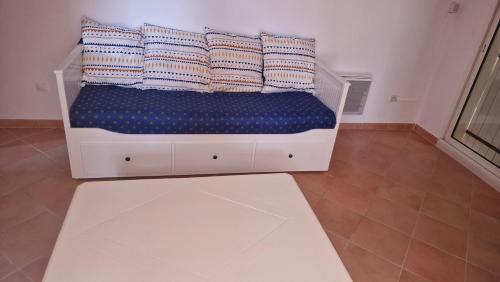 a white bed with pillows on it in a room at Villa au pied de la sainte Victoire in Puyloubier