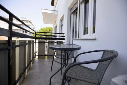 a patio with a table and chairs on a balcony at Hotel Elite in Cervia