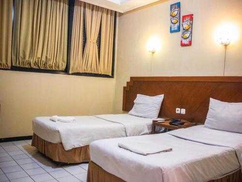 Krevet ili kreveti u jedinici u okviru objekta Hotel Sukamulya Pasteur