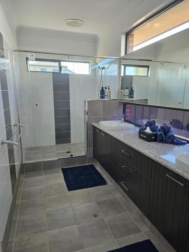 a large bathroom with a sink and a shower at Private guest suite in Perth
