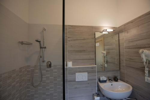 a bathroom with a shower and a sink and a shower at Hotel Elite in Cervia
