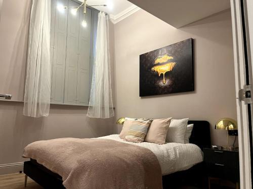 a bedroom with a bed and a painting on the wall at Bella Ruiz city centre Manchester in Manchester