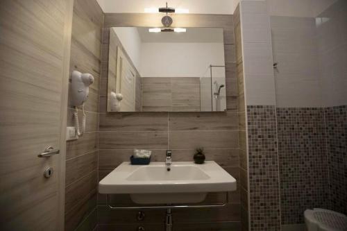a bathroom with a sink and a mirror at Hotel Elite in Cervia