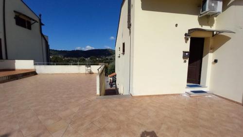 an open door of a building with a patio at Monolocale Azzurra in Magione
