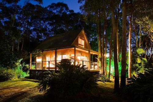 a house in the middle of a forest at night at Buddha's Bungalow in Byron Bay