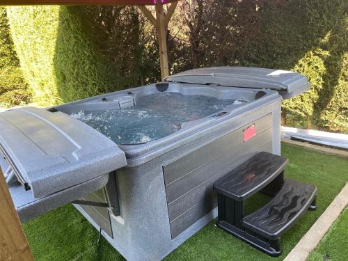 a hot tub sitting on the grass in a yard at Swallow lodge in Lincolnshire