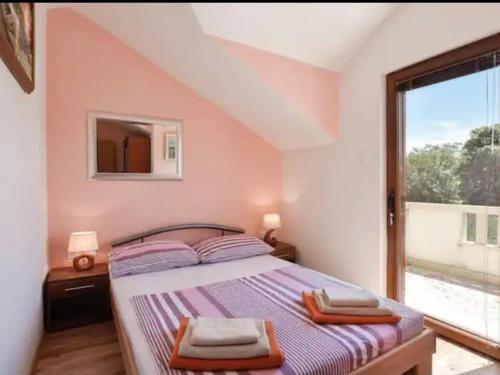 a bedroom with a bed with a mirror and a window at Charming holiday home with private pool and covered terrace in Škrip