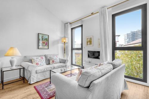 a living room with two couches and a large window at Rosario - Joli T3 climatisé dans Toulouse in Toulouse