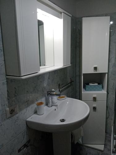 a bathroom with a white sink and a mirror at La Dimora di Pietra in Gubbio