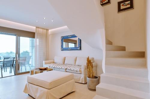a living room with a couch and a stair at MiLiON RESIDENCES in Parga