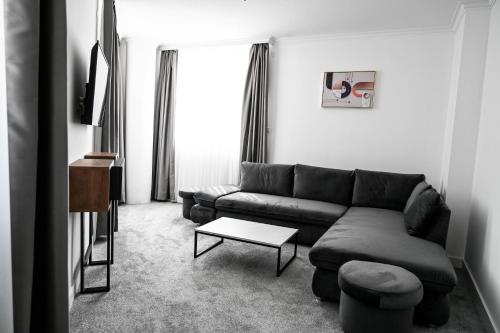 a living room with a couch and a table at Hotel LIBERO Delchevo in Delčevo