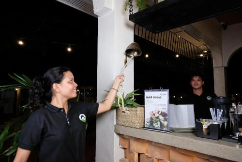 a woman is holding a magnifying glass at Mad Monkey Dumaguete in Dumaguete