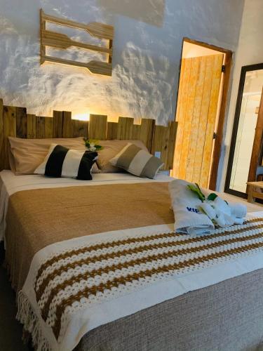 a bedroom with a large bed in a room at Chalés XIÉ in São Miguel dos Milagres