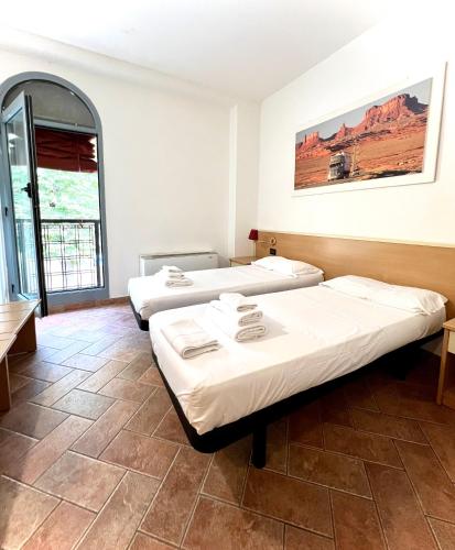 a room with three beds and a window at SAGOSTINO HOUSE in SantʼAgostino