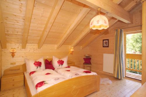 a bedroom with a bed in a wooden room at Jagdhaus Wagrain in Wagrain