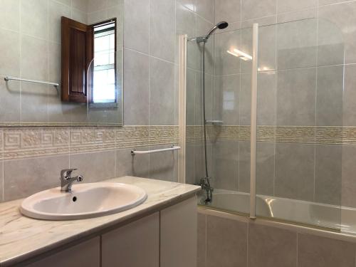 a bathroom with a sink and a shower at Casa das Eiras in Tondela