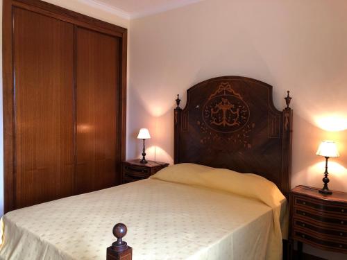 a bedroom with a large bed and two night stands at Casa das Eiras in Tondela