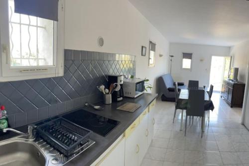 a kitchen with a sink and a stove top oven at calme et paisible in La Ciotat